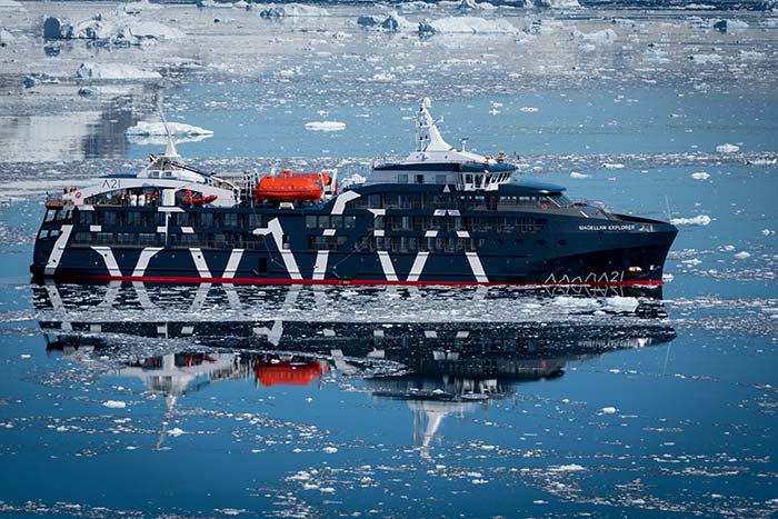 Photo of a cruise ship in water with glaciers