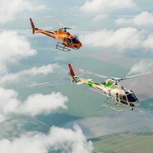 Photo of two helicopters in the clouds