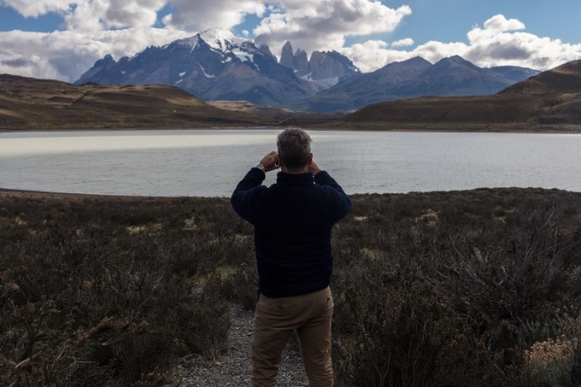 Photo of a man taking a photo of the Hotel Las Torres grounds with mountains in background