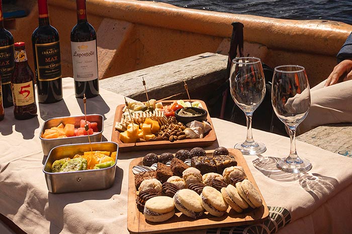 Photo of food and wine on a boat